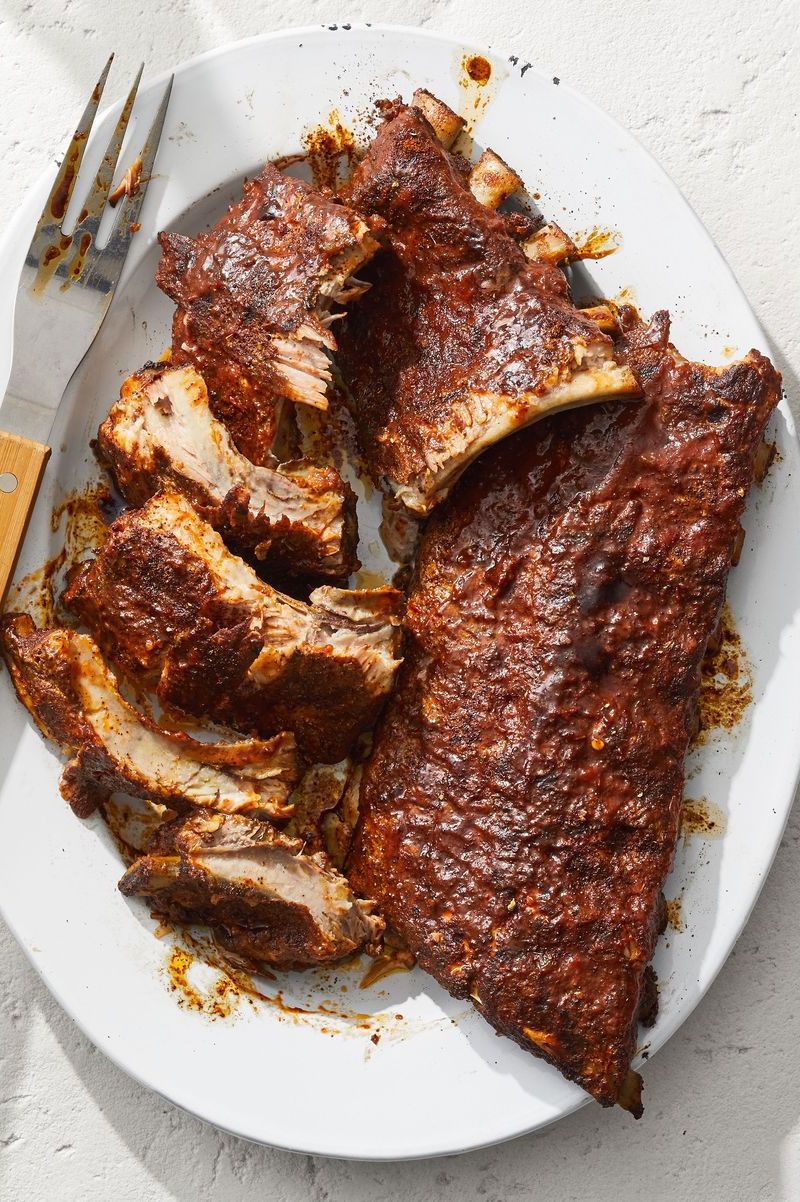 barbecue ribs with bbq sauce on a white plate