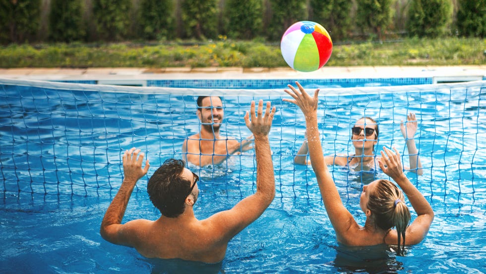 friends playing pool volleyball