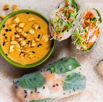 rice paper rolls filled with noodles, veggies, and shrimp and served with a peanut dipping sauce