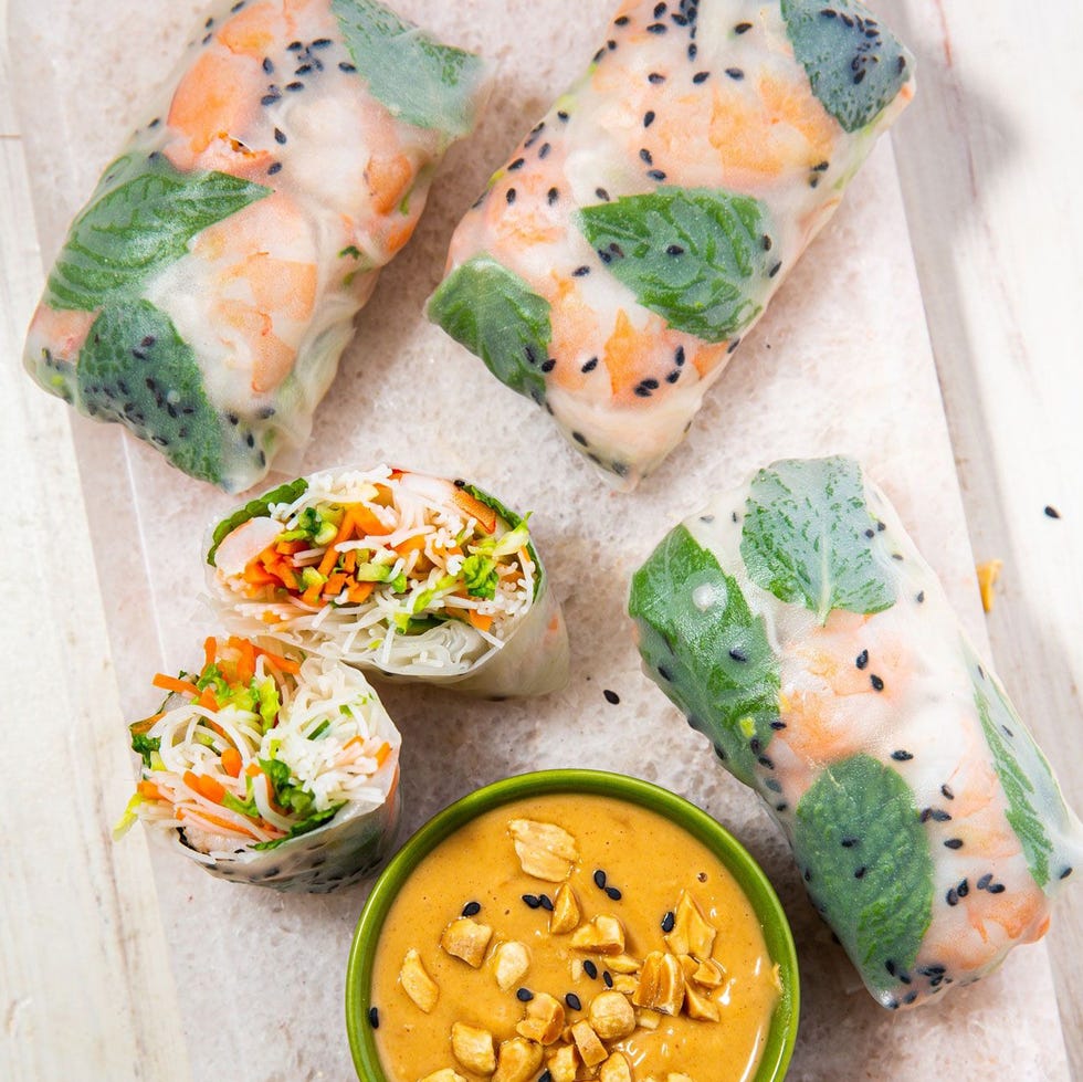 rice paper rolls filled with noodles, veggies, and shrimp and served with a peanut dipping sauce