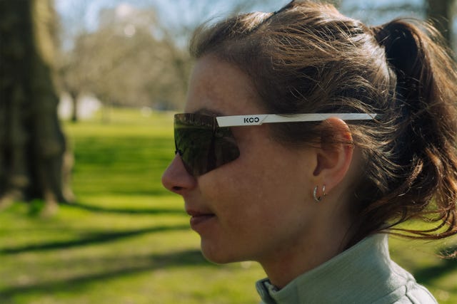 a woman looking to the side wearing a pair of large sunglasses