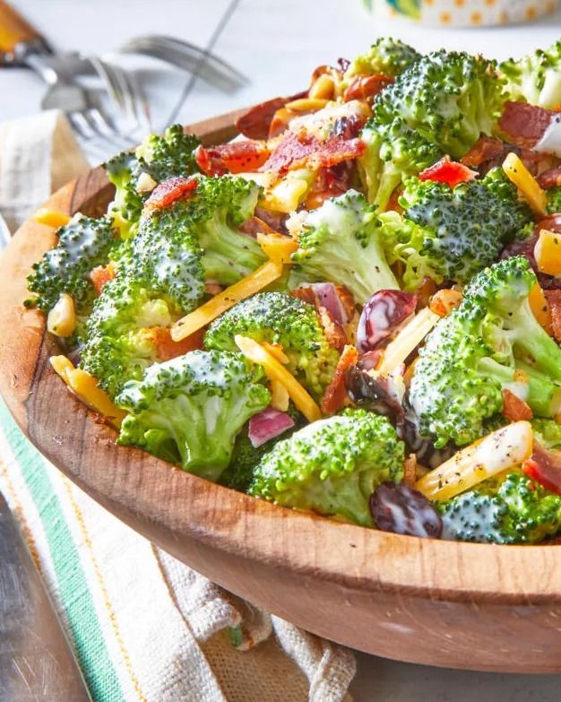 broccoli salad with cheddar cheese in wood bowl