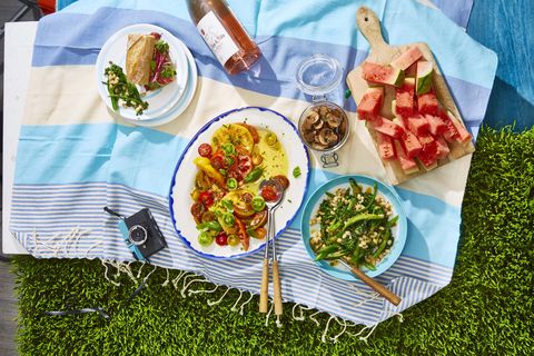 white bean and broccolini salad, heirloom tomato salad, both on a picnic blanket