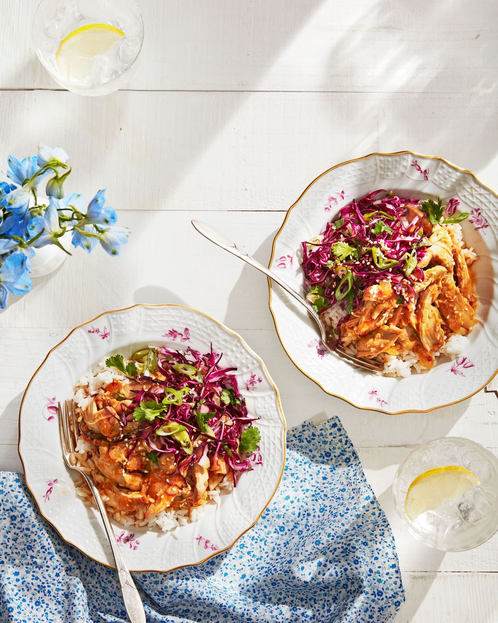 two bowls of gingery slow cooker chicken with cabbage slaw with forks