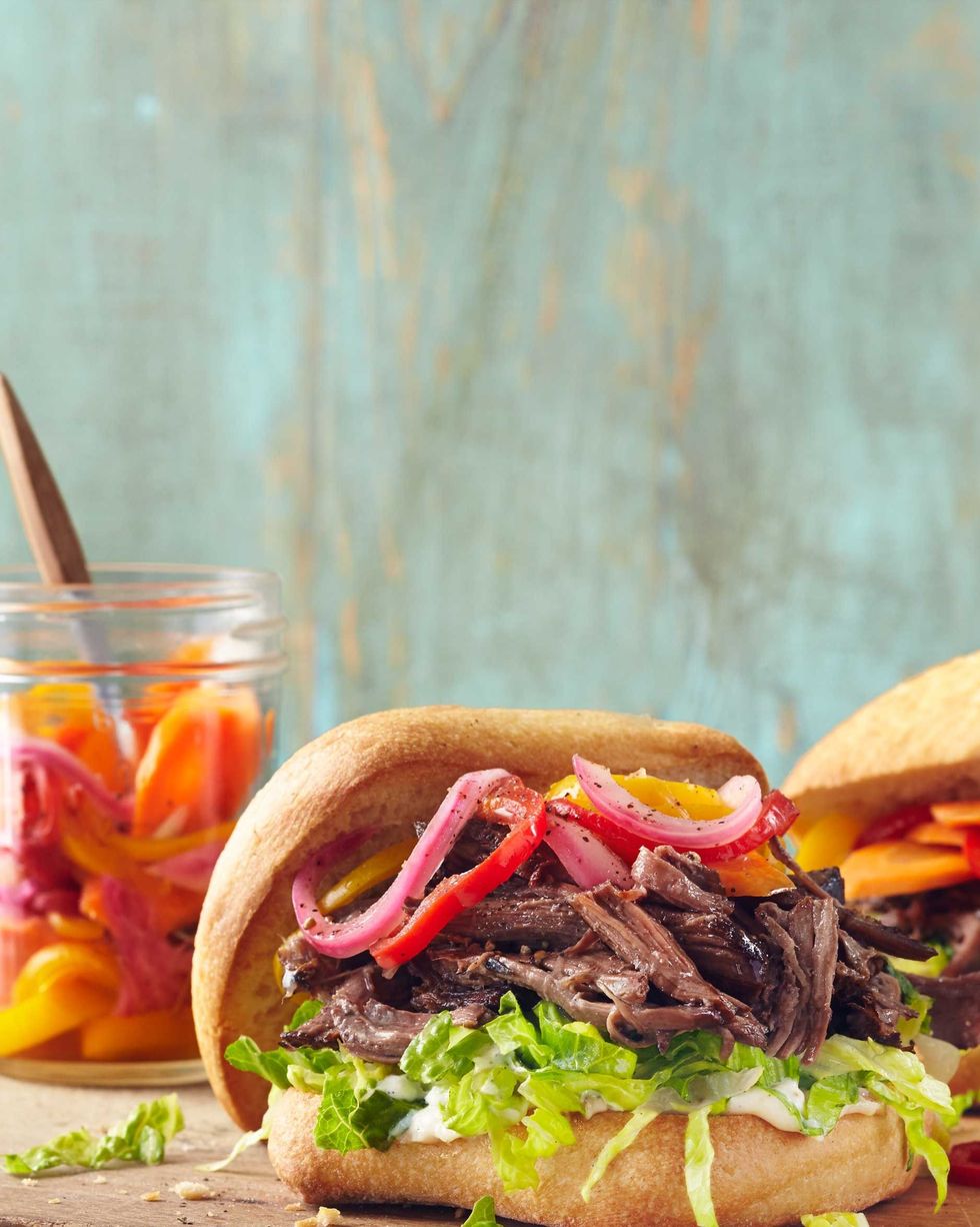 summer slow cooker roast beef sandwiches on a wooden serving board
