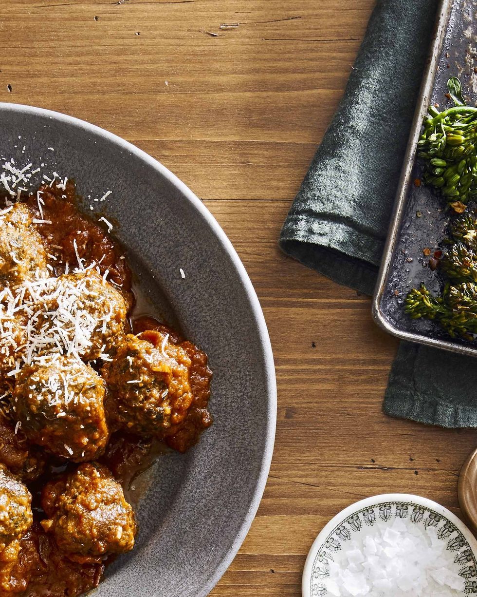 slow cooker spinach and parmesan meatballs piled on a metal serving tray