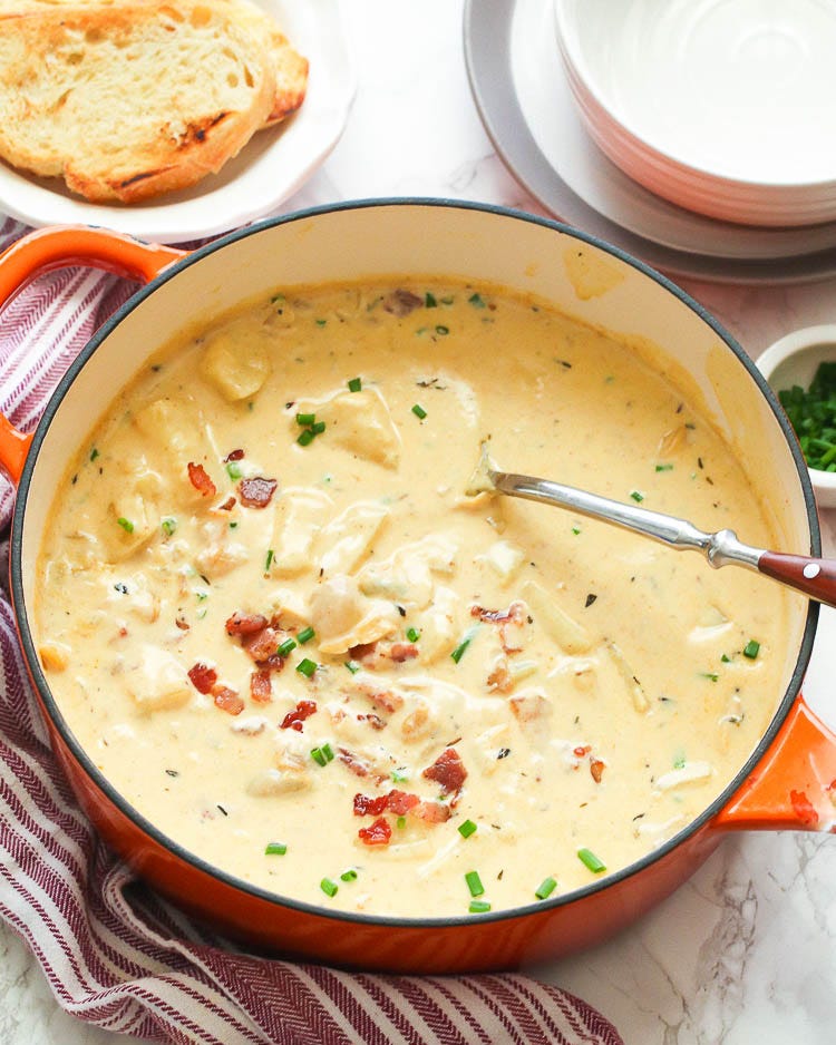 new england clam chowder in orange dutch oven