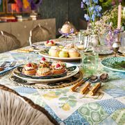 a colorful easter table setting with pastries and metal chairs