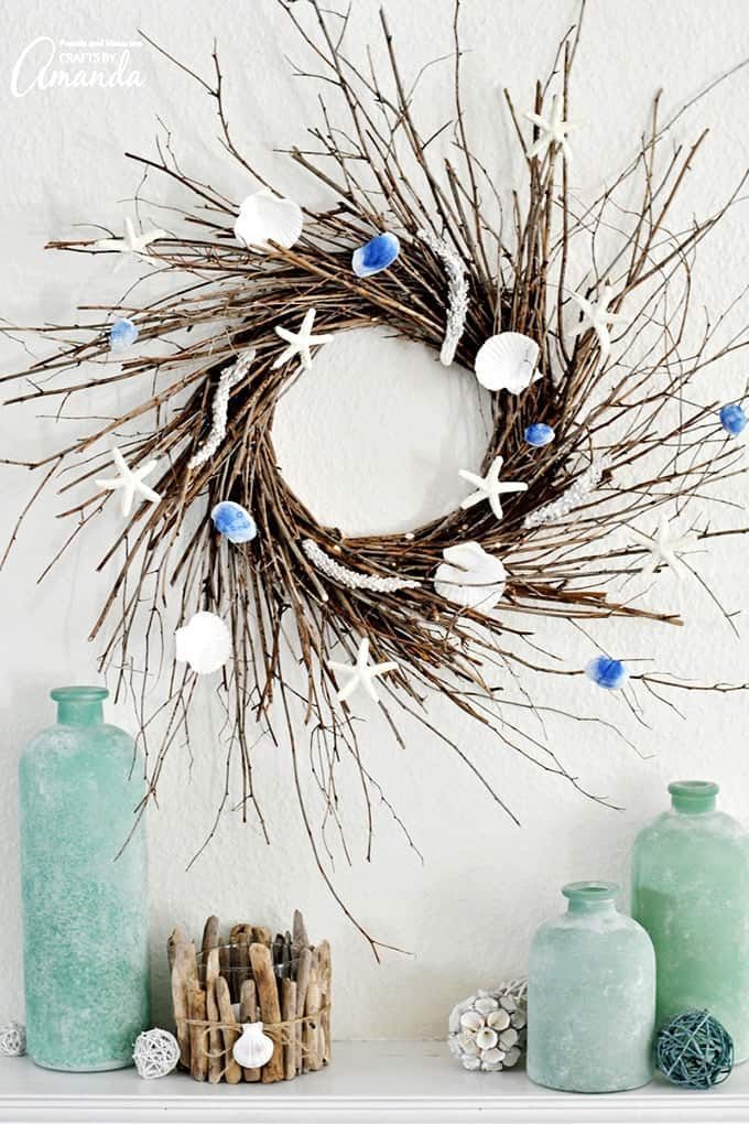 summer wreath made of sticks and decorated with small blue and white shells and starfish