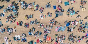 sunbathers relaxing on southend beach as seen from directly above, southend on sea, essex, united kingdom