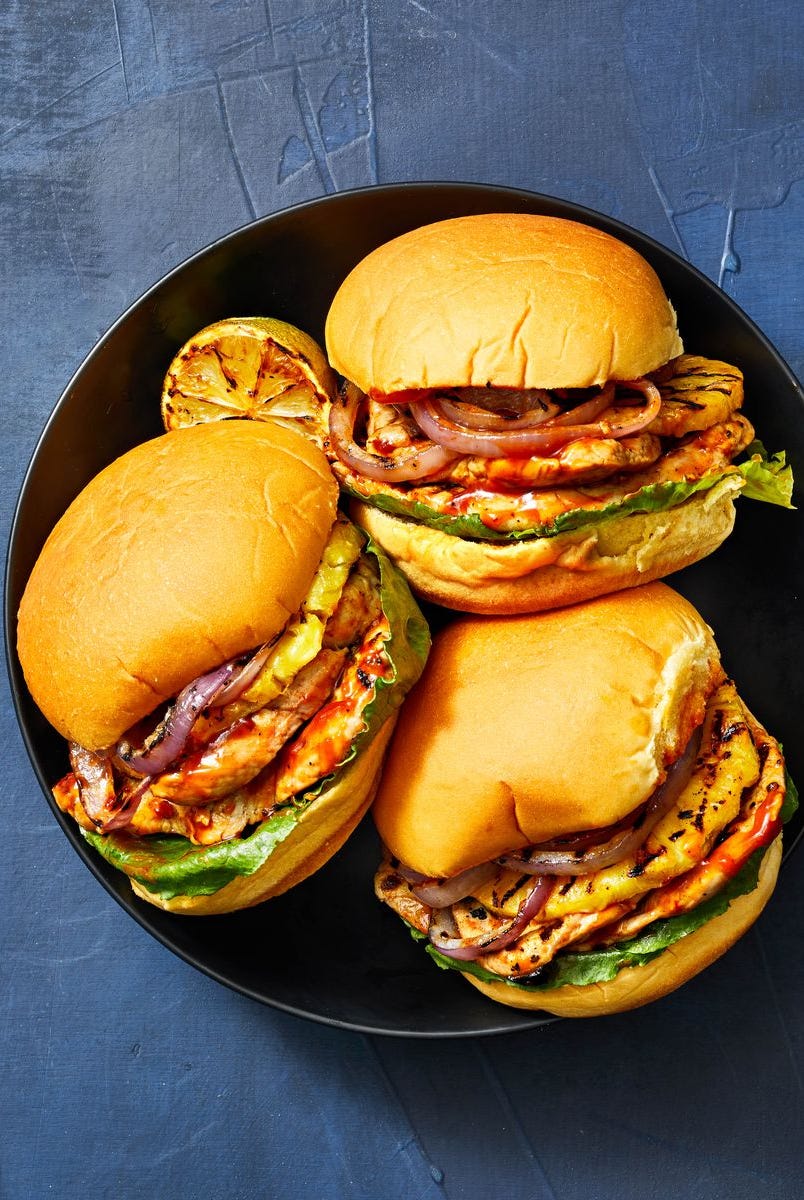 sunday dinner ideas grilled pork pineapple sandwiches grilled pork pineapple burgers on a black plate