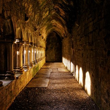 sunlit corridor in ruins of 15th century quin abbey, county clare, ireland the abbey is free and open to the public