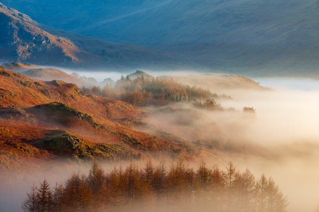 Sunrise above fog with a Lake District landscape, UK.