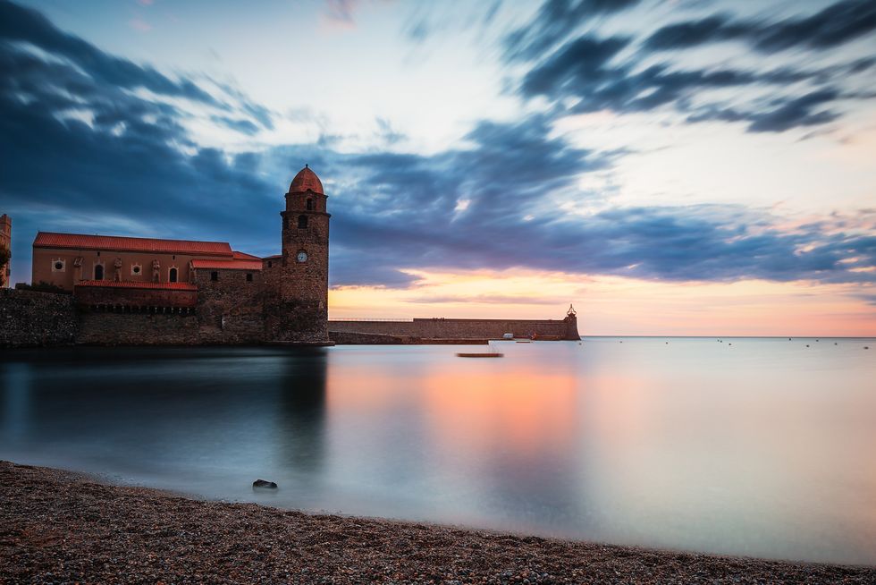 sunrise at "plage des pêcheurs" in front of "Église notre dame des anges" of collioure, france