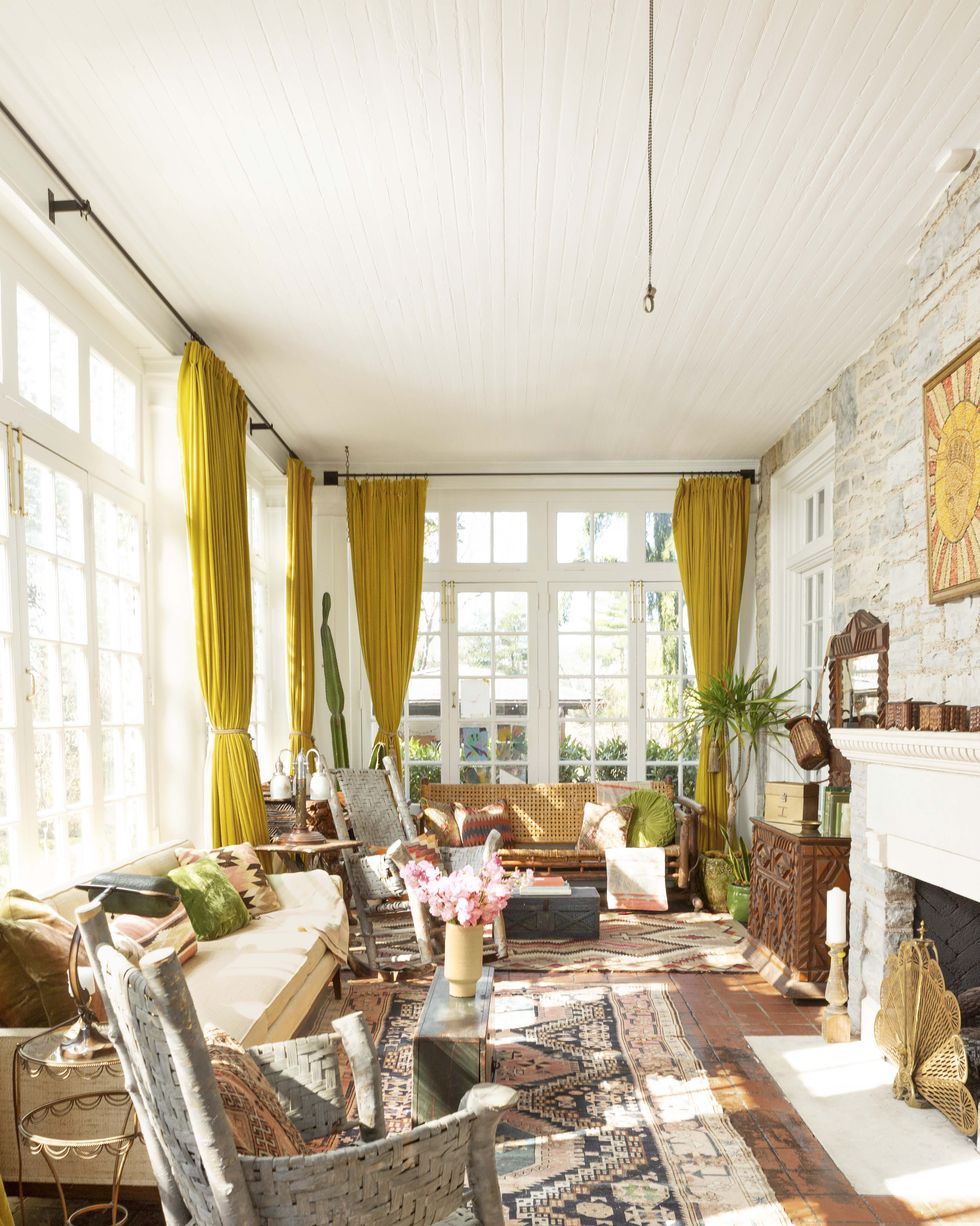 sunroom with yellow curtains and adirondack style rocking chairs