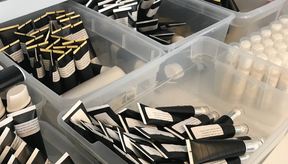 a collection of sunscreens with labels blinded in separate bins in the gh beauty lab