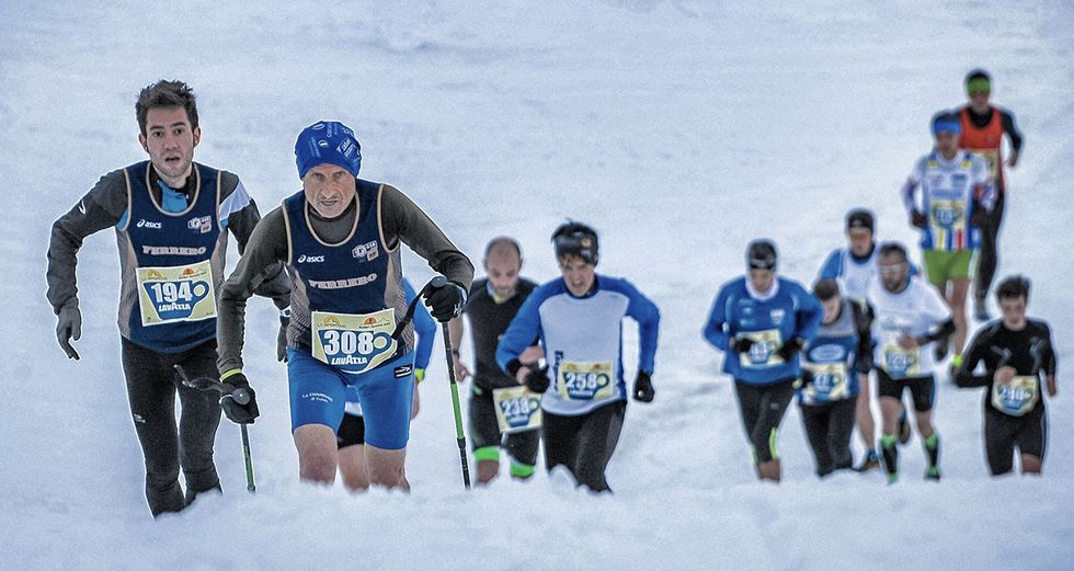 a group of people running in the snow