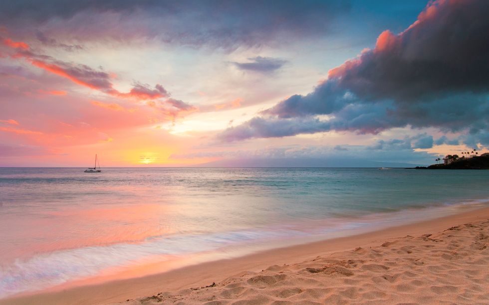 Sunset at beach with boat in distance, Kaanapali, Maui, Hawaii, USA