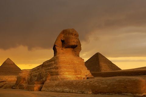 sunset at the sphinx and pyramid complex giza, egypt
