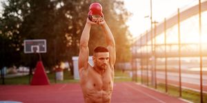 handsome man working exercises in early morning with sunrise fitness training outdoors