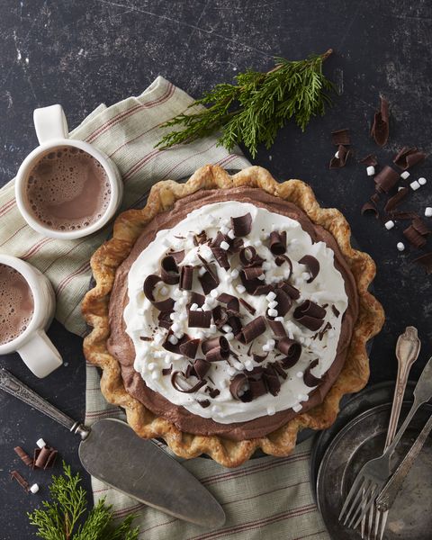 hot chocolate ice box pie topped with whipped cream chocolate curls and mini marshmallows