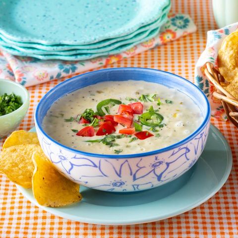 easy queso dip in blue and white bowl with chips