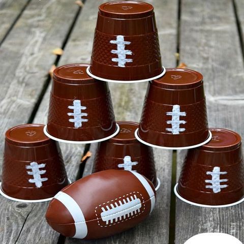 super bowl party ideas, football themed cups stacked on top of each other