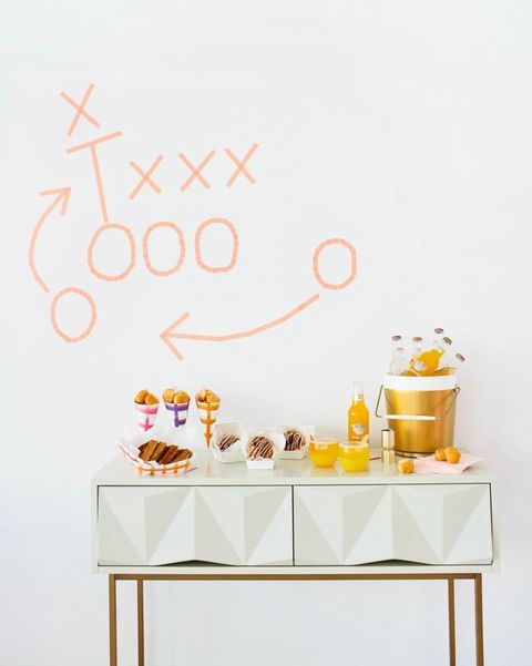 super bowl party ideas, table with desserts and writing on the wall