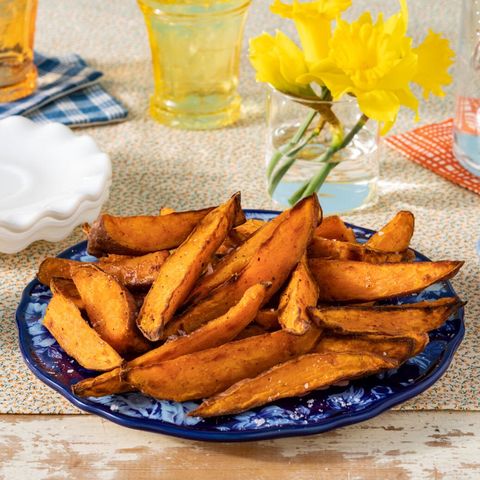 super bowl recipes air fryer sweet potato fries on blue plate with yellow flowers in back