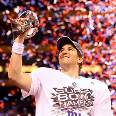 INDIANAPOLIS, IN - FEBRUARY 05:  Eli Manning #10 of the New York Giants hoist the Vince Lombardi Trophy after defeating the New England Patriots in Super Bowl XLVI at Lucas Oil Stadium on February 5, 2012 in Indianapolis, Indiana. The New York Giants defeated the New England Patriots 21-17.  (Photo by Al Bello/Getty Images)
