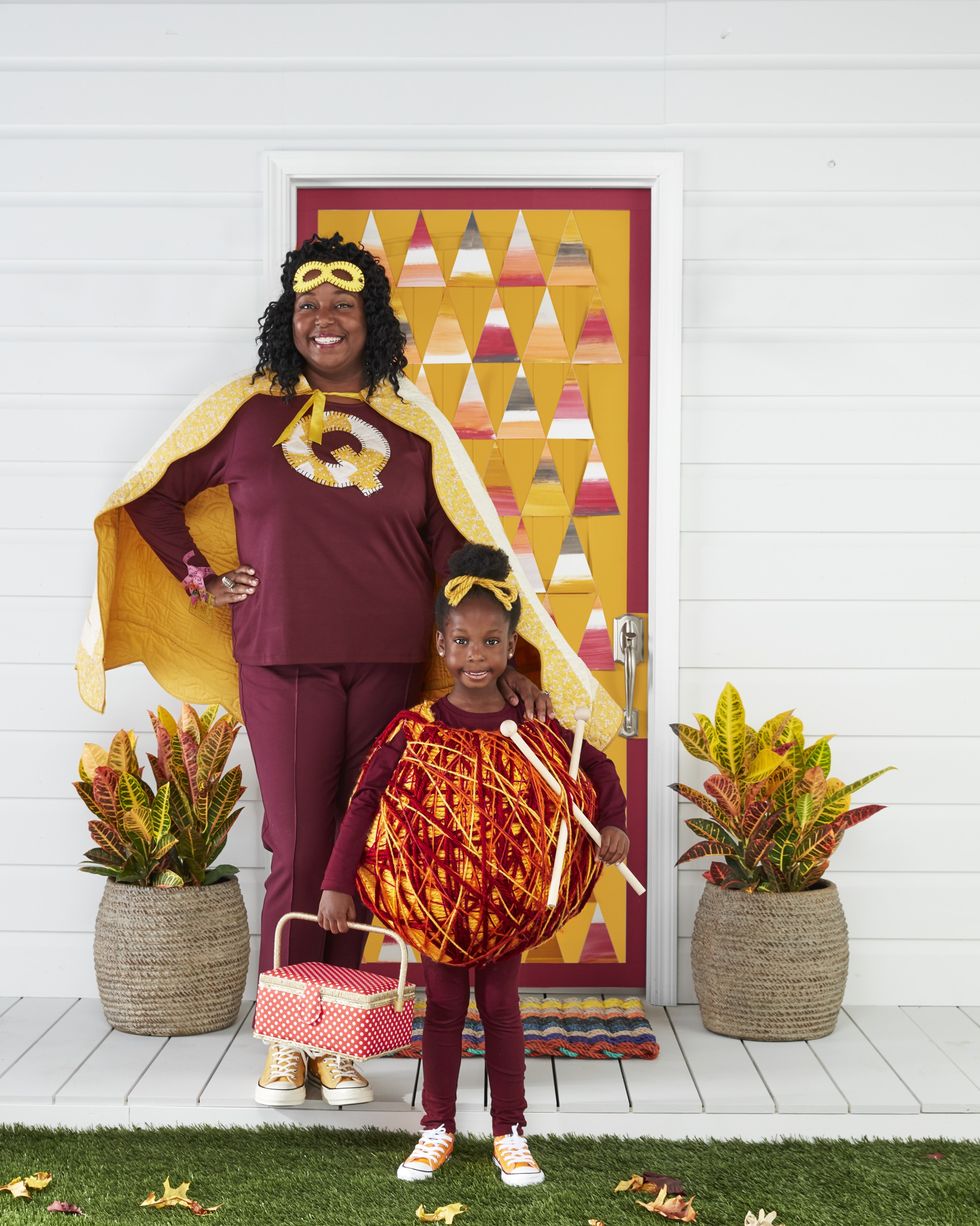 mother and daughter in superquilter and yarn girl diy family costume standing on front porch