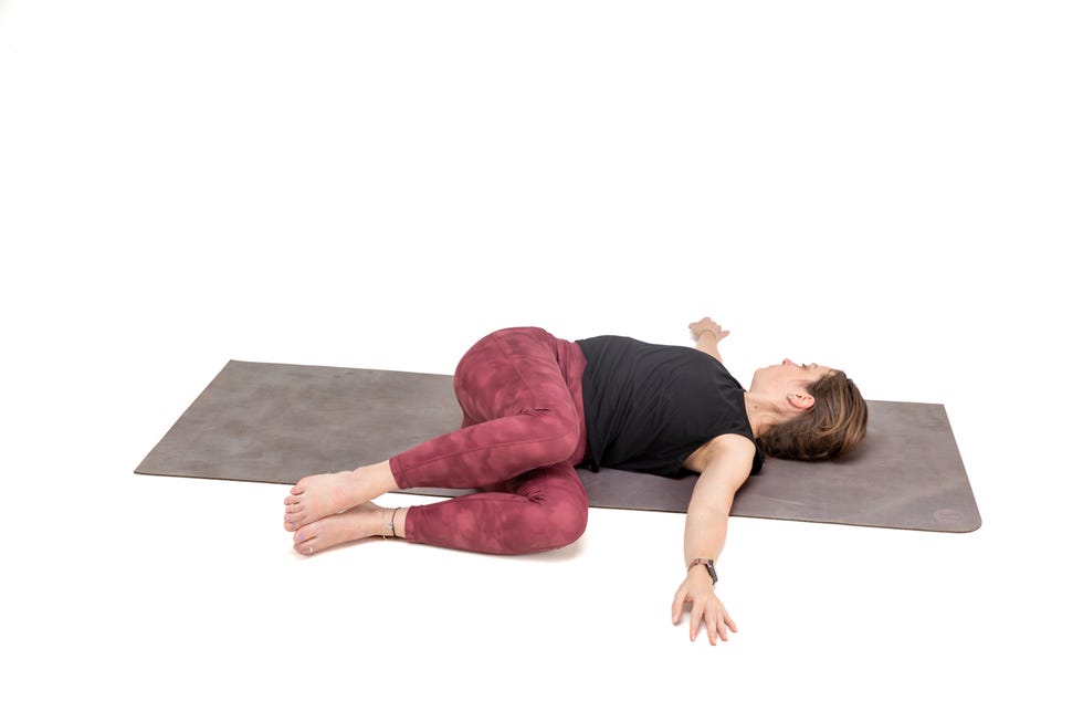 a woman doing yoga against a white background