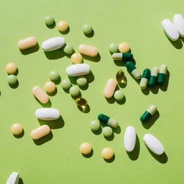 Colorful pills and capsules on green background. Minimal medical concept. Flat lay, top view. colorful pills and capsules on green background minimal medical concept flat lay, top view