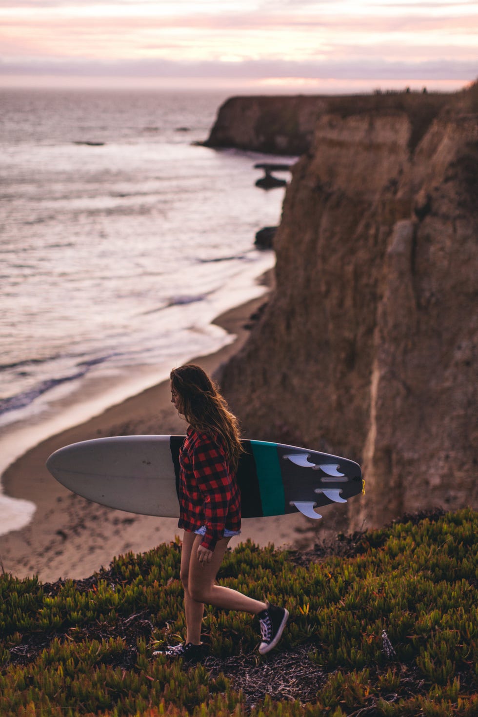 surfer with surfboard on hill, santa cruz, california, usa