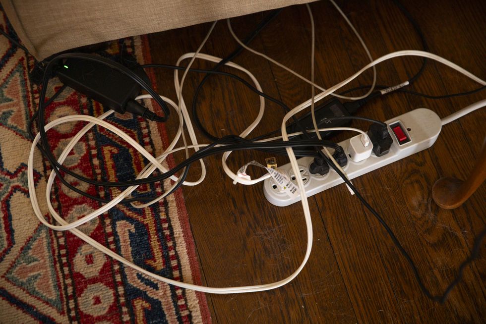 surge protector power strip, messy cables and electrical cords, phone charger cable