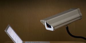 surveillance camera peering into laptop computer