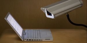 surveillance camera peering into laptop computer
