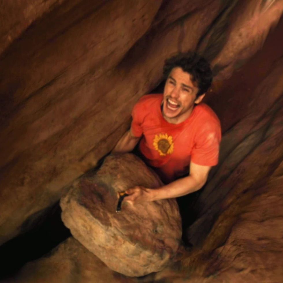 127 hours, a good housekeeping pick for best survival movies, stars james franco in a based on a true story tale of man who was trapped alone in a canyon unable to move