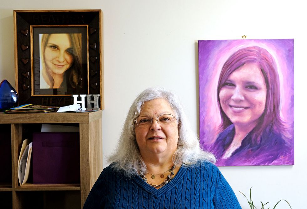 Susan Bro stands by Heather Heyer portrait