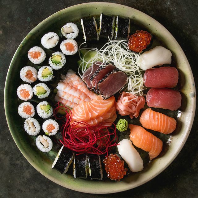 sushi set nigiri sashimi and sushi rolls in ceramic serving plate