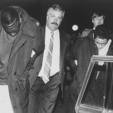 Suspect Yusef Salaam (l.) is led away by a detective after b