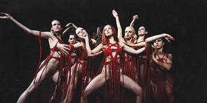 suspiria movie still featuring dakota johnson and a group of people posing in underwear and red thread