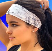woman outside wearing sweat sports headband while exercising