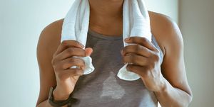 sweat soaked woman finishes indoor cycling session