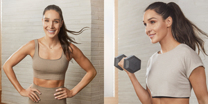 kayla itsines in a brown sports bra and leggings smiling at the camera