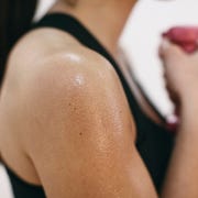 sweaty shoulder of woman doing fitness workout