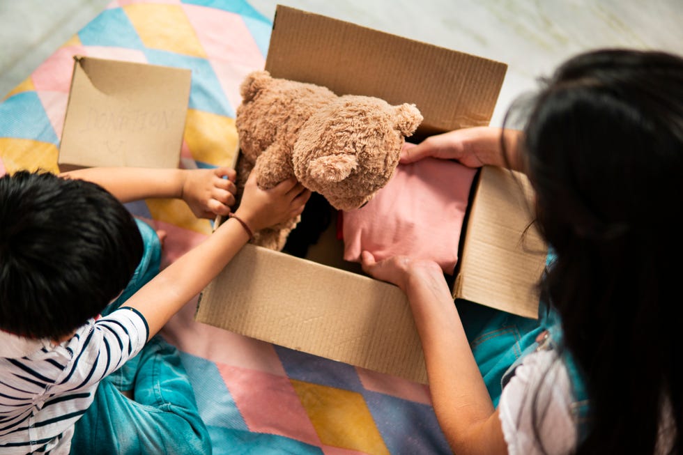 swedish death cleaning, girl and boy packing toys in boxes