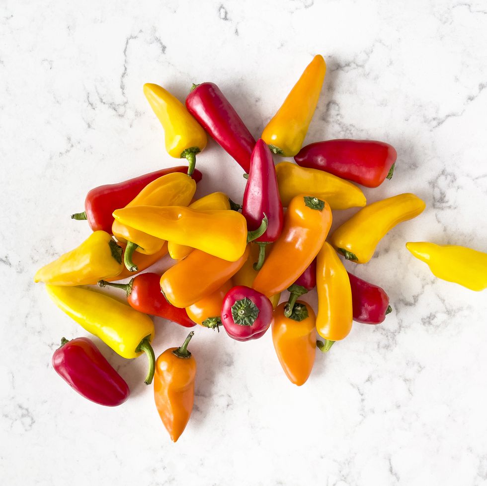 sweet mini bell peppers on white background