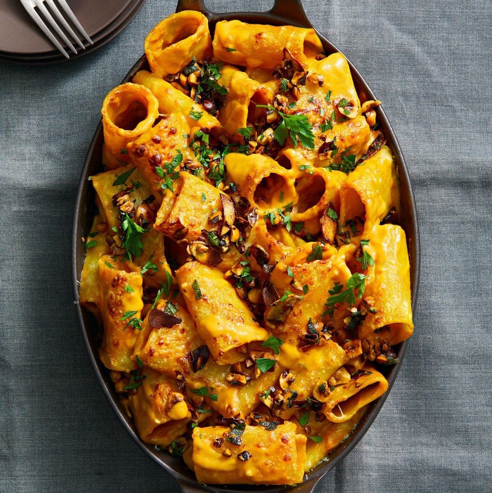 sweet potato baked pasta with hazelnuts on top in a dish
