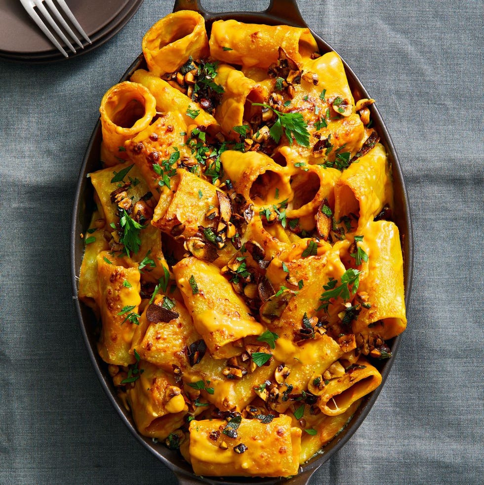 butternut squash baked pasta with chopped nuts on top
